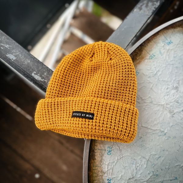 Nomad Waffle Knit Beanie in Marigold. Small black tag on front of the beanie reads "Upstate of Mind".