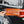 Load image into Gallery viewer, Upstate of Mind Bumper Sticker | Someone holding up an orange background with darker orange trees and tan text that reads "Upstate of Mind", in front of a black SUV car.