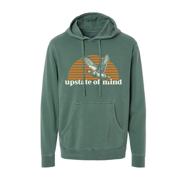 A Duck Season Hoodie made by Upstate of Mind! Featuring a duck flying across a striped golden orange sunset, with text below that reads "Upstate of Mind".