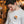Load image into Gallery viewer, A model wearing the Upstate of Mind In The Clouds Longsleeve Tee in a moody, warmly light shop.
