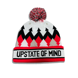A photo of the Upstate of Mind North Country Pom Beanie in Red/White/Black. Inspired by the Adirondack Thunder hockey team.