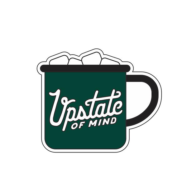 A sticker design of a green enamel hot coca mug with marshmallows sticking out on top and "Upstate of Mind" text on the front.