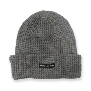 Nomad Waffle Knit Beanie in Charcoal. Small black tag on front of the beanie reads "Upstate of Mind".