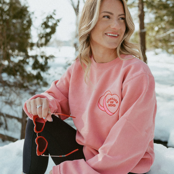 A model wearing the Candy Hearts Crewneck.