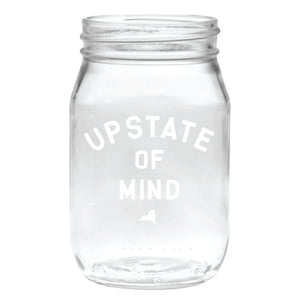 Our popular Upstate of Mind Mason Jar Pint Glass. Clear glass with white text on the front of the mason jar that reads "Upstate of Mind".