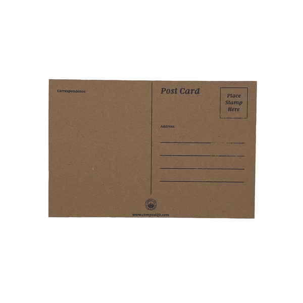 Back of "ADVENTURE AWAITS" postcard. Printed on brown cardboard paper. There is space to write an address, a message, and a place for a tamp. Compas Life logo on the bottom.