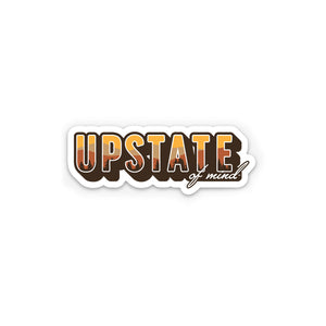 A sticker of "Upstate of Mind" text, with a mountain view of autumn colors within the "Upstate" letters.
