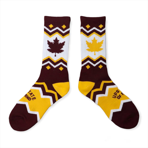 Upstate of Mind Maple Leaf Socks. Colors are burgundy and yellow with chevron stripes, blocks of yellow/burgundy, a yellow maple leaf print, a burgundy leaf print, and text that reads "Upstate of Mind".