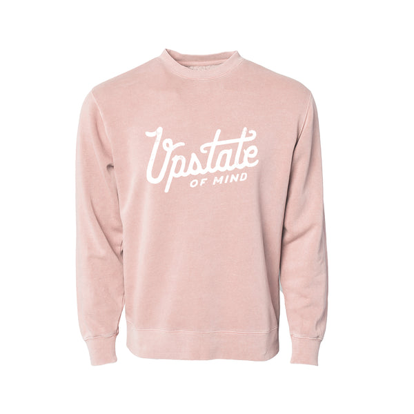 Upstate of Mind - Heritage Script Crewneck - Dusty Rose. This crew neck is a super comfy, pigment-dyed fleece that is designed for comfort.  Soft hand feel print on a vintage washed sweatshirt.  Graphic reads "Upstate of Mind" in a large heritage script text.
