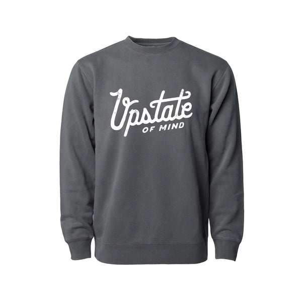 Upstate of Mind - Heritage Script Crewneck - Slate Wash. This crew neck is a super comfy, pigment-dyed fleece that is designed for comfort.  Soft hand feel print on a vintage washed sweatshirt.  Graphic reads "Upstate of Mind" in a large heritage script text.