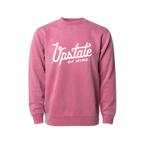 Upstate of Mind - Heritage Script Crewneck - Raspberry Wash. This crew neck is a super comfy, pigment-dyed fleece that is designed for comfort.  Soft hand feel print on a vintage washed sweatshirt.  Graphic reads "Upstate of Mind" in a large heritage script text.