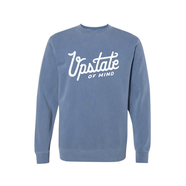 Upstate of Mind - Heritage Script Crewneck - Navy Wash. This crew neck is a super comfy, pigment-dyed fleece that is designed for comfort.  Soft hand feel print on a vintage washed sweatshirt.  Graphic reads "Upstate of Mind" in a large heritage script text.